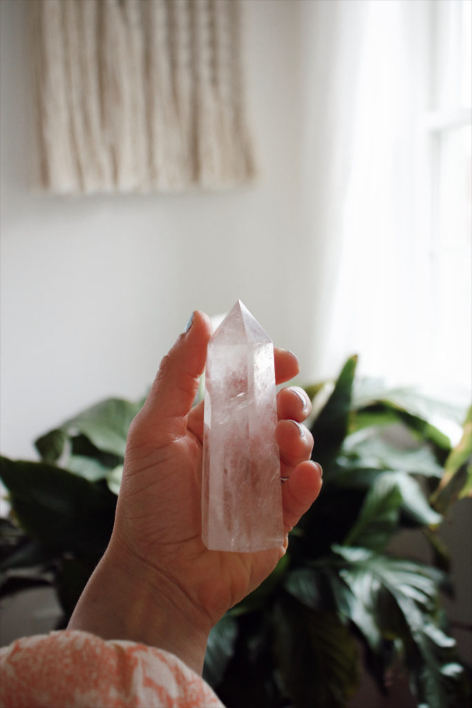 ana holding a clear quartz stone in her hand