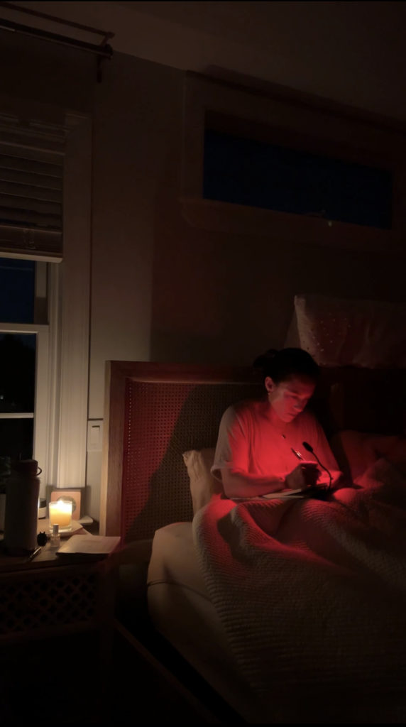 Ana reading with the BluBlox red light sleep clip.
